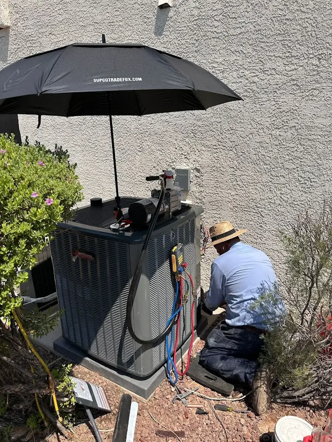 HVAC technician performing outdoor AC maintenance in Mentor